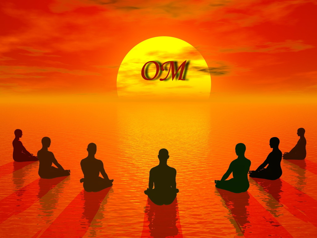 Human sitting in lotus position and meditating in front of the sun by beautiful sunset